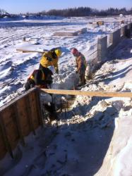 Snow covered ground foundation construction in field